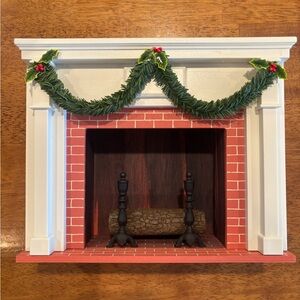Charming Holiday Fireplace Decor with Green Garland